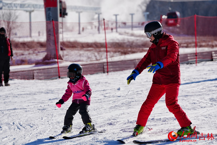 在吉林北大湖滑雪度假區，一名小朋友在教練的指導下學習滑雪。人民網記者 李洋攝