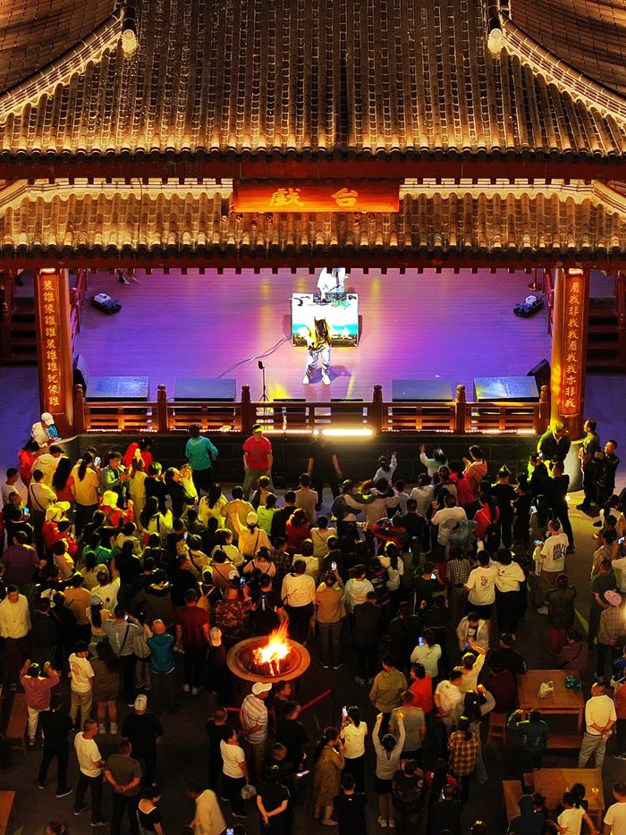 游客在小鎮戲臺前欣賞表演。人民網記者 李洋攝